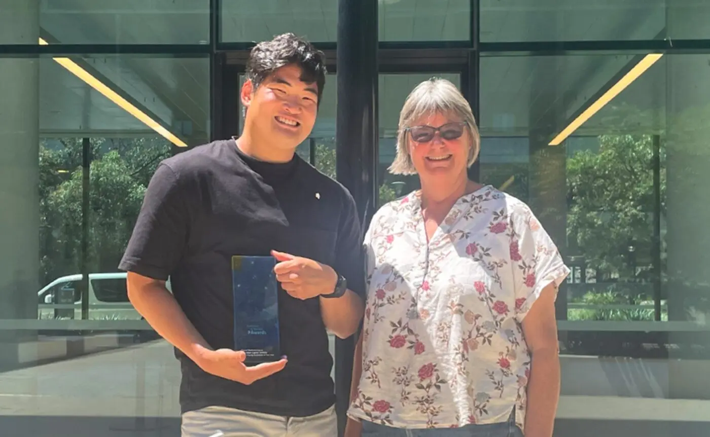 Daniel poses with the ACT Young Australian of the Year trophy, alongside his mother, Joanna.