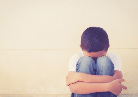 boy huddled