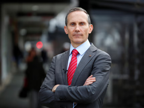 Andrew Leigh MP looking serious with crossed arms