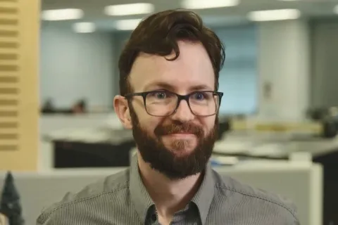 Gordon Douglas, a man with beard and glasses, smiles at camera