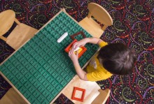 child seated at a learning table