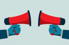 hands holding megaphones pointed at each other