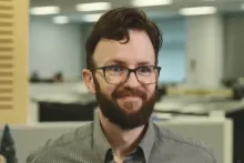Gordon Douglas, a man with beard and glasses, smiles at camera